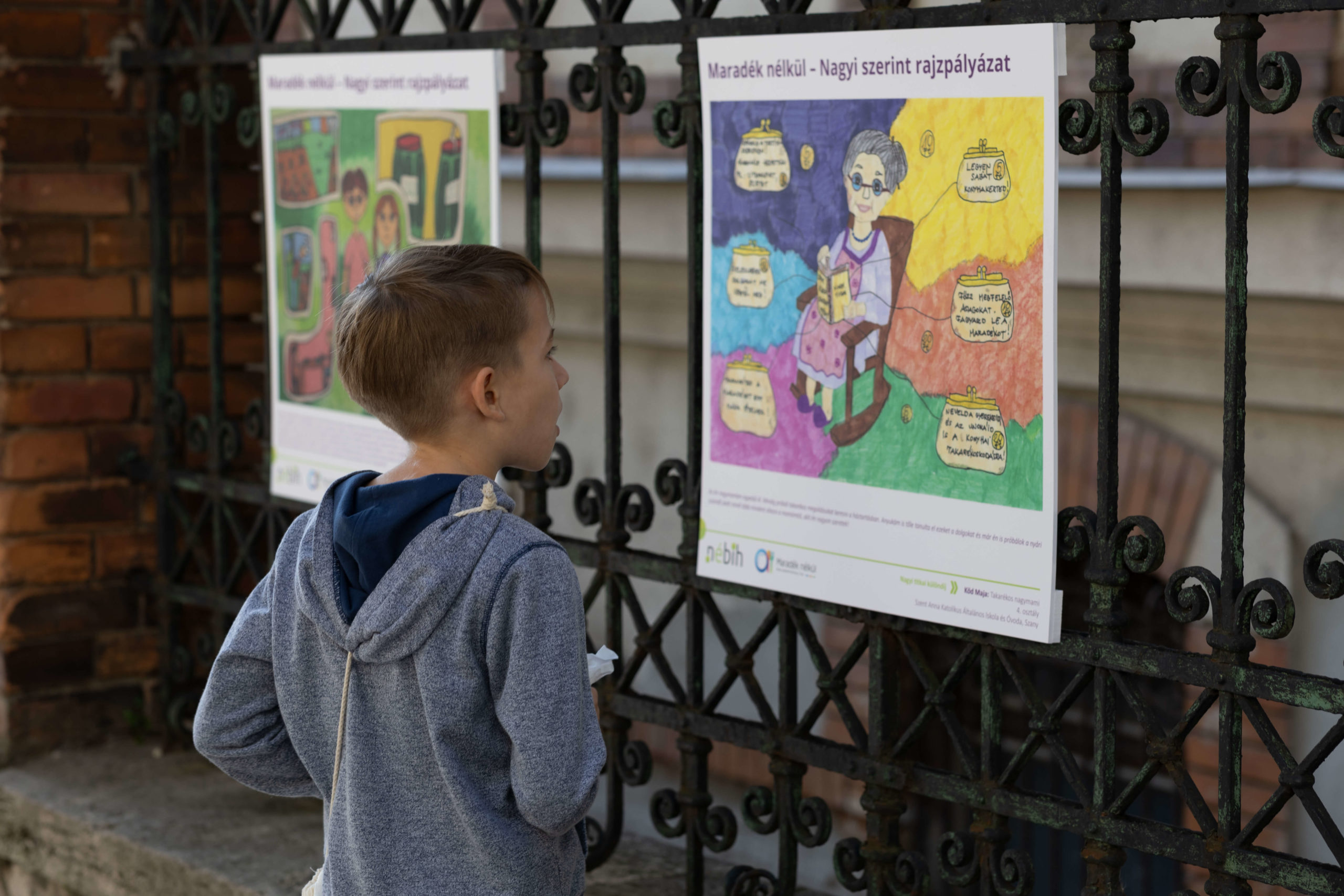 gyerek nézi az egyik rajzot